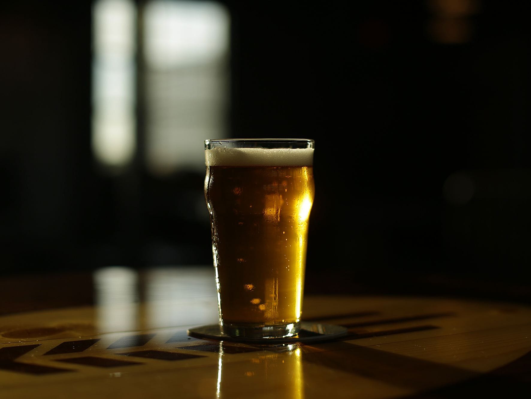 A beer sits on a table in downtown Green Bay.