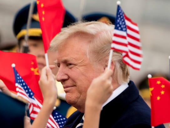 File photo shows children waving U.S. and Chinese flags