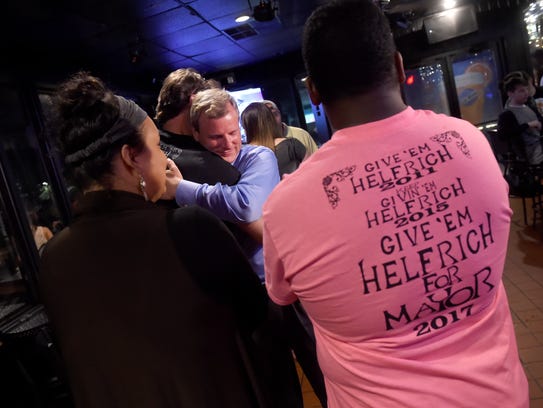 York city mayoral candidate Michael Helfrich is embraced