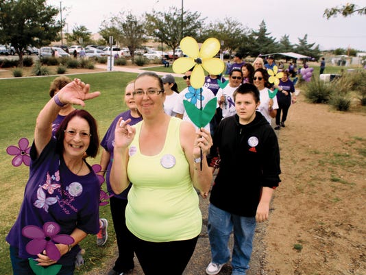 Bill Armendariz - Lighthouse Photo
Members of Willow Manor's Assisted Living Team, Beverly Fiorentino, left, and Melissa Kern, show their joy and support during the Walk to End the Alzheimer's Disease that took place on Saturday morning at the Parc des Voiers. The march was organized by the staff of the Mimbres Memorial Hospital and the Alzheimer's Association of New Mexico. Deming is one of six cities in New Mexico that organized a march to raise awareness and make money.