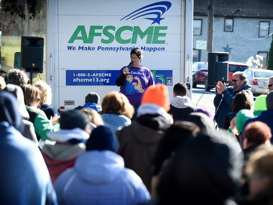 Union president Penny Kleinfelter speaks to strikers and supporters from the back of a truck Friday afternoon during the Cedar Haven Nursing home rally held to mark the four week anniversary of the walk out.