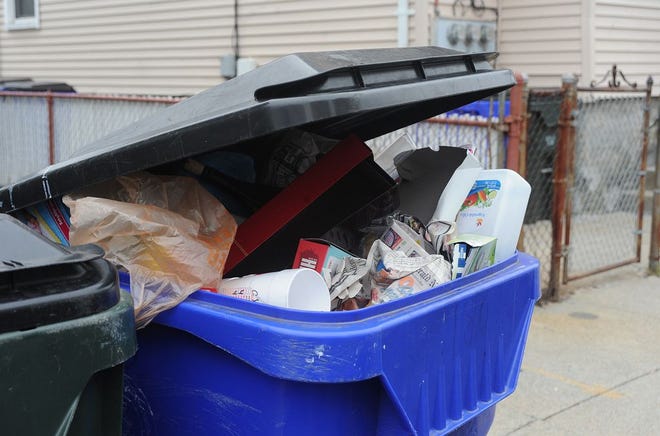 A trash bin overflows with garbage in Fall River.