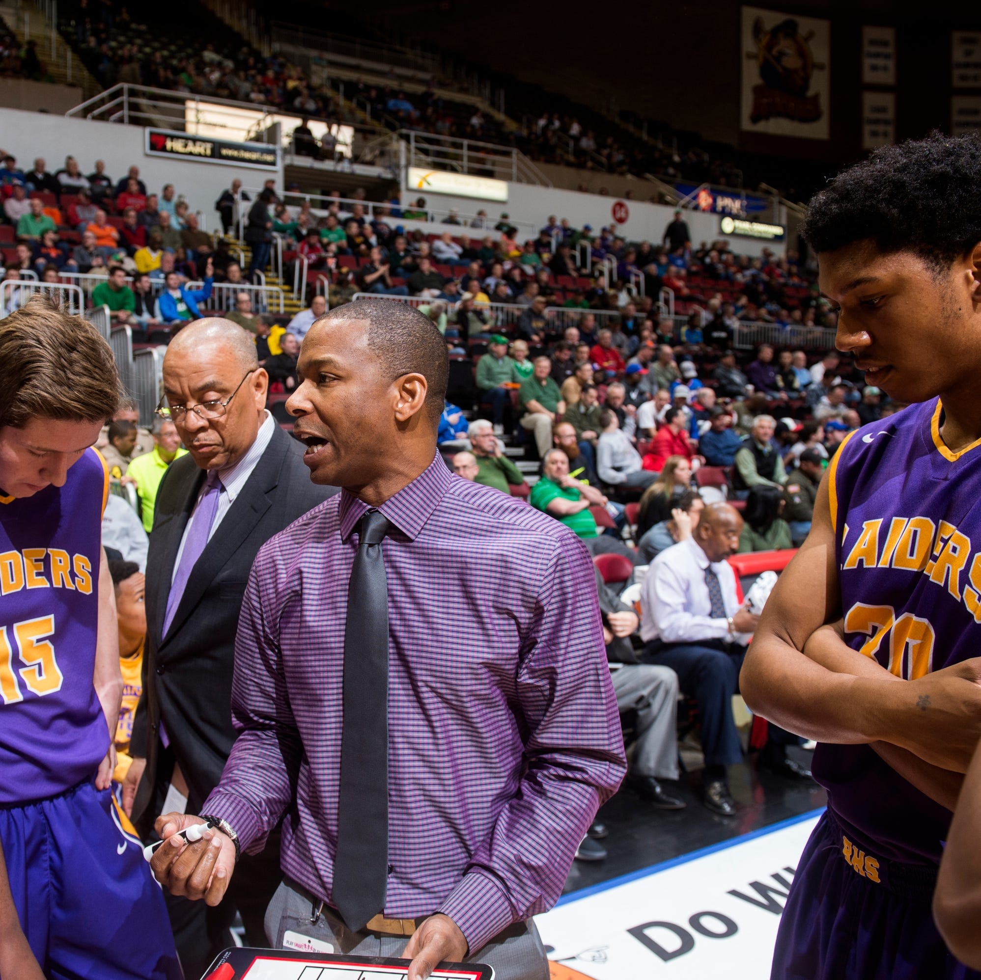 Bloomington coach Micheal Mosley fires up his team in the huddle. Oak Park Fenwick beat Bloomington 67-52 in their 2017 Class 3A semifinal game at the Peoria Civic Center.