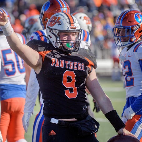 Washington quarterback Tyler Humphrey signals a first down after his run against East St. Louis in the first half of their Class 6A football state semifinal game Saturday, Nov. 18, 2023 at Babcook Field in Washington.