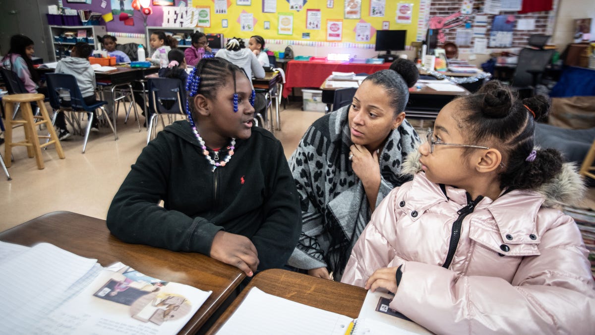 Teri Scott, a fourth-grade teacher the Cross Hill Academy in Yonkers, works with JaÕmyla Smith and Zendaya Garner on a reading assignment Jan. 8, 2023. New York Governor Kathy Hochul has announced that she will introduce legislation to require schools to use "the science of reading" curriculum. She announced that $10 million will go toward training 20,000 teachers on it. The Science of Reading is a curriculum that uses phonics, vocabulary, fluency, and comprehension to teach kids how to read.