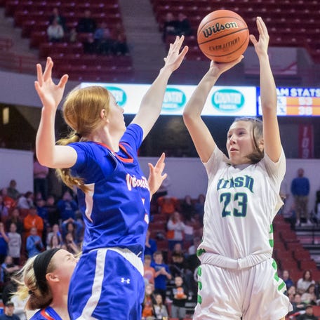 Peoria Notre Dame's Emy Wardle (23) puts up the game-winning shot over Nashville's Summer Brinkmann, top left, and Emma Behrmann in the final second of their Class 2A girls basketball state title game Saturday, March 2, 2024 at CEFCU Arena in Normal. The shot gave the Irish a 48-46 victory.