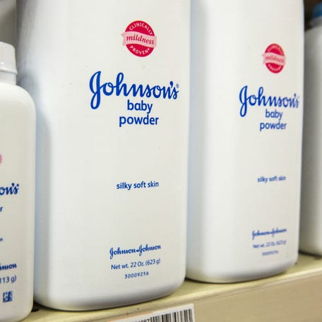 Bottles of Johnson & Johnson baby powder line a drugstore shelf in New York October 15, 2015.