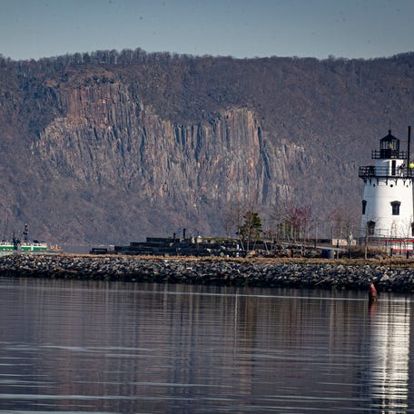 A tug boat pushing a barge up the Hudson River passes the Tarrytown Lighthouse as it heads towards its destination in Newburgh April 9, 2024.