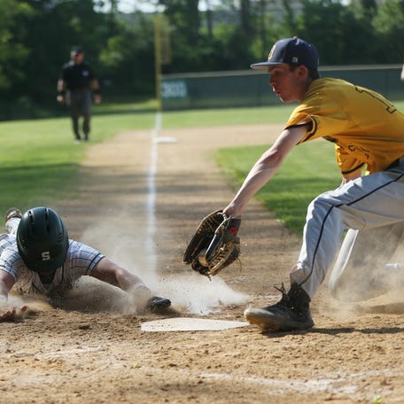 Spackenkill's Dylan Boenig slides home safe under Highland's Hunter Tomlin during the Section 9 Class B semifinal on May 21, 2024.
