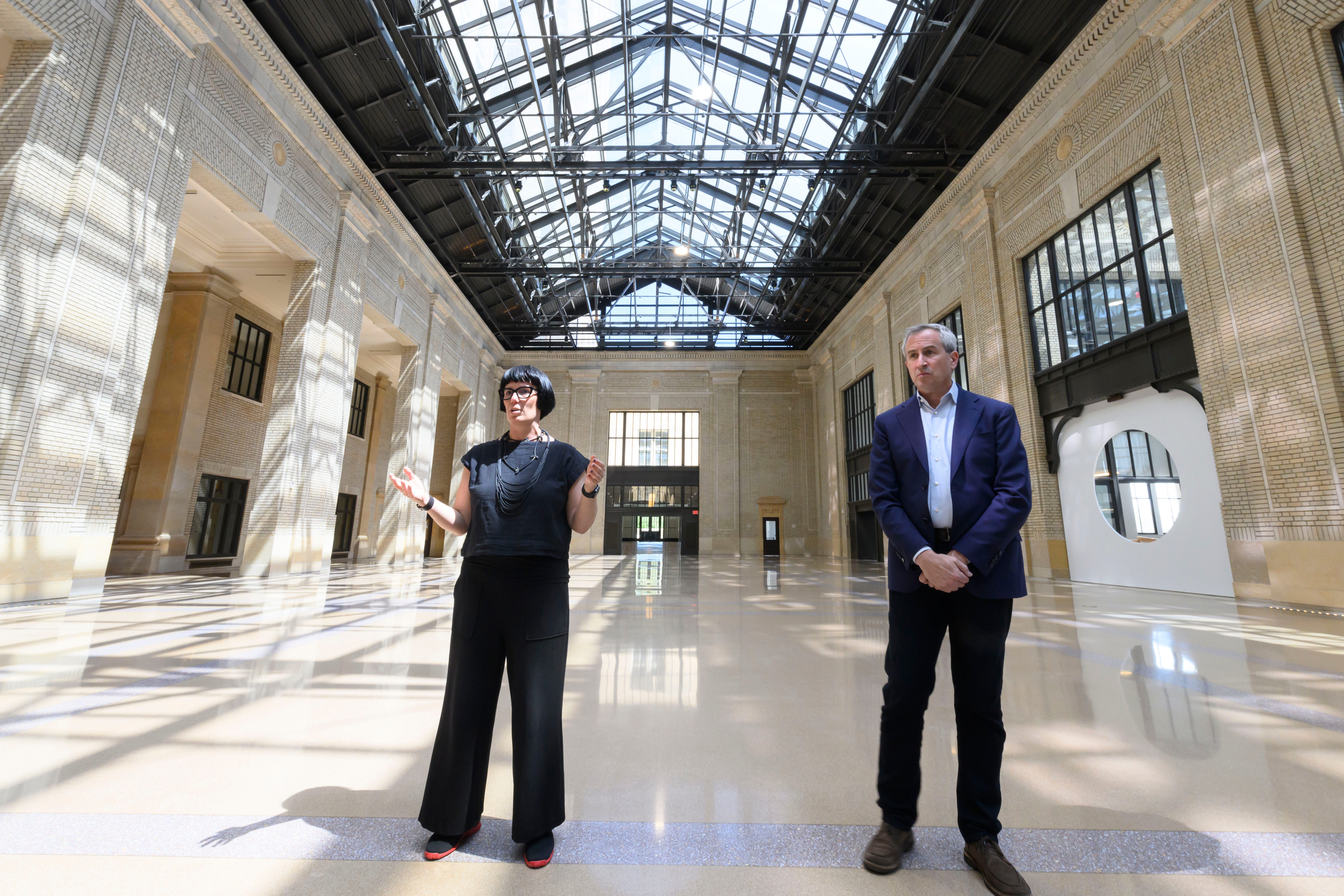 Melissa Dittmer, Head of Place for Michigan Central, left, and Josh Sirefman, the Chief Executive Officer of Michigan Central, stand inside the renovated atrium at the Michigan Central Station, in Detroit, May 13, 2024.