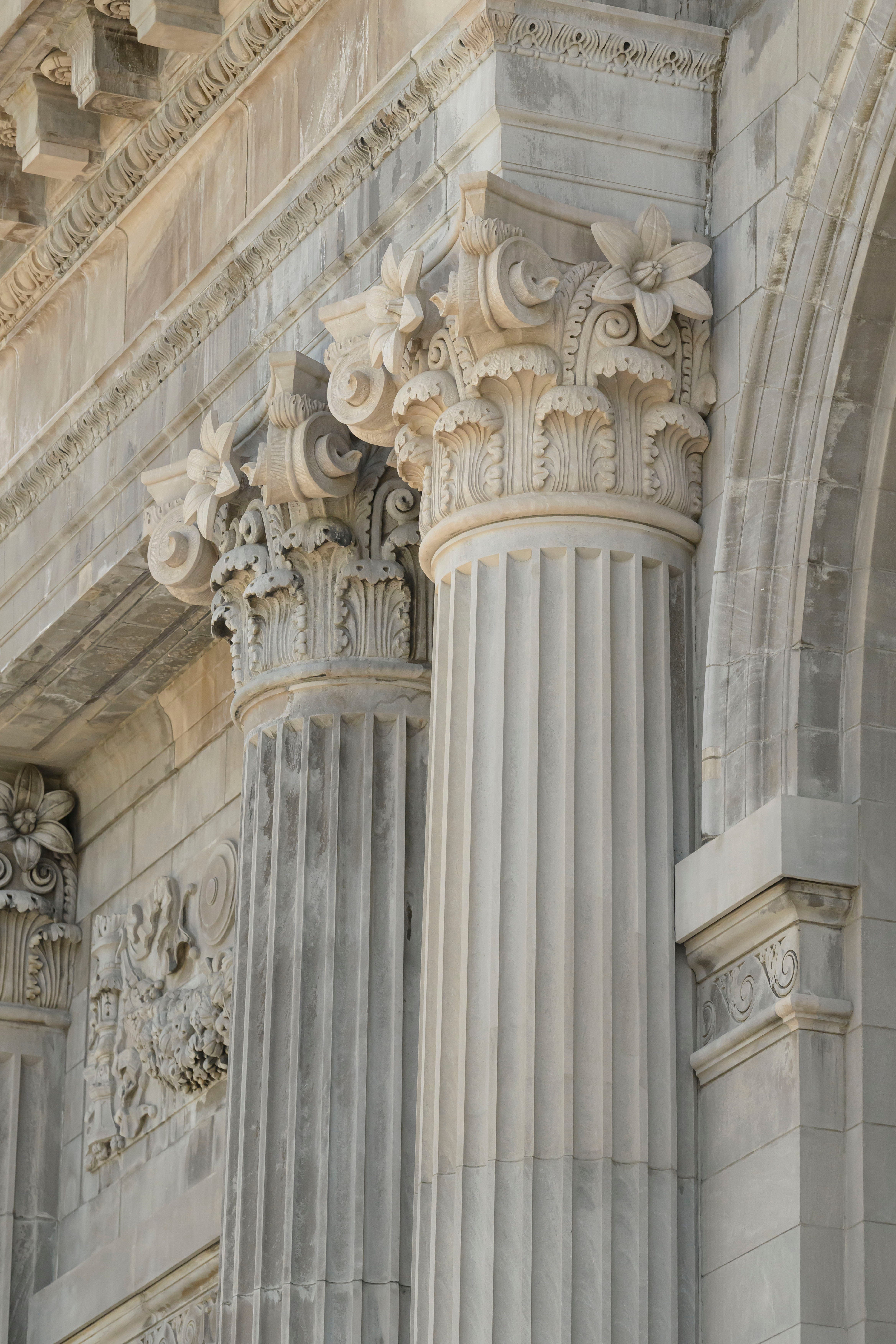 An original column and a hand carved new column next to each other can be seen on the renovated exterior of the Michigan Central Station.