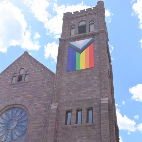 Pastor Martell Spagnolo poses for a portrait outside First Congregational Church in downtown Sioux Falls on June 2, 2022. The church proudly displays a Progress pride flag, representing parts of the traditional gay rainbow flag, transgender pride flag in chevron and black and brown chevron stripes for people of color.