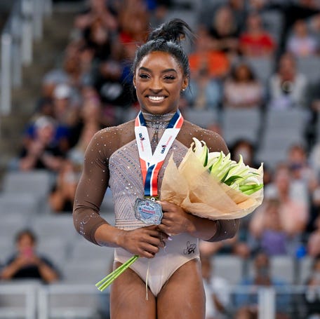 Jun 2, 2024; Fort Worth, Texas, USA; Simone Biles of World Champions Centre poses for a photo with her gold medal and commemorative belt buckle after finishing in first in the women's 2024 Xfinity U.S. Gymnastics Championships at Dickies Arena.