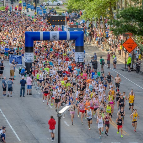 Runners funnel through the starting gate of the 2024 Steamboat Classic early Saturday, June 15, 2024 in downtown Peoria.