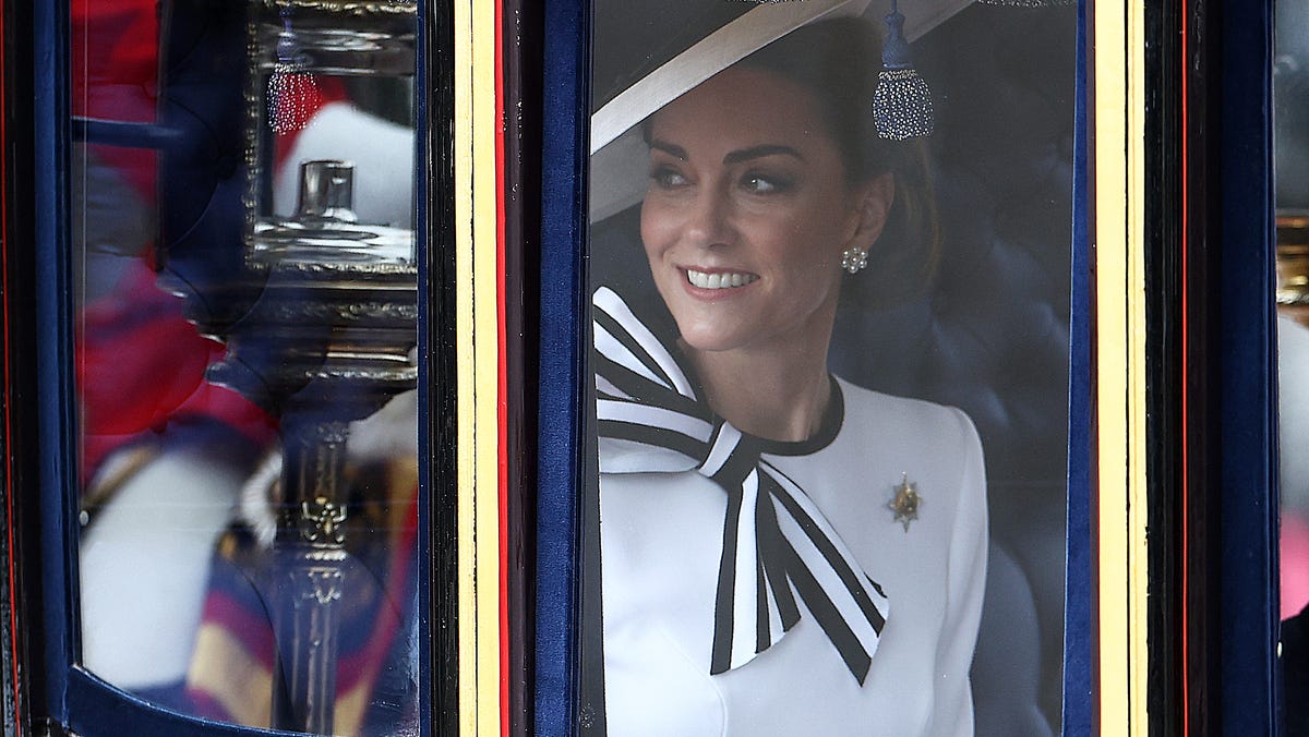 Princess Kate smiles inside the Glass State Coach on her way to Horse Guards Parade for the King's Birthday Parade "Trooping the Colour" in London on June 15, 2024.