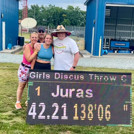 Marlboro's Juliana Juras poses with her parents, Paola and Bob Juras, and coach Tom Fassel after winning the girls championship discus at the Adidas Outdoor Nationals on June 16, 2024 at North Carolina A&T University.