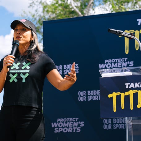 Former U.S. Rep. Tulsi Gabbard speaks at an Our Bodies, Our Sports rally in June.