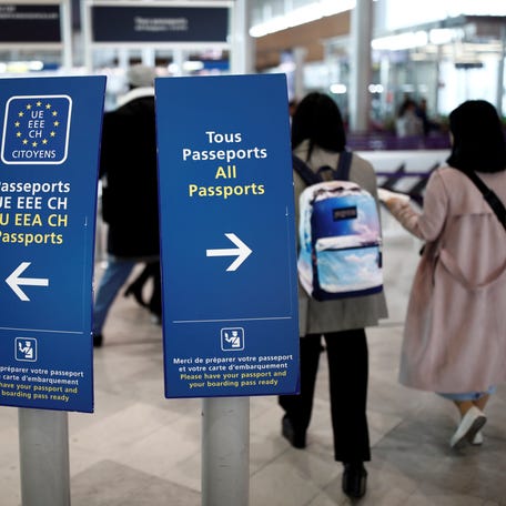 Directional signs for passport control are seen at Charles de Gaulle airport, operated by Aeroports de Paris, in Roissy, France, April 11, 2019.