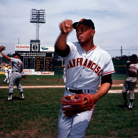 San Francisco Giants center fielder Willie Mays plays catch on the field.