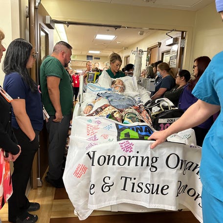 Loved ones and staff gather around Patrice Sanders at her honor walk on Thursday, June 13, 2024 at Community Regional Medical Center in California.
