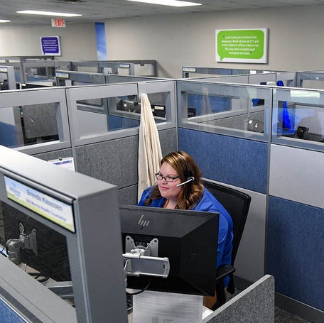Helpline Center employees take calls on Wednesday, July 13, 2022, in Sioux Falls.