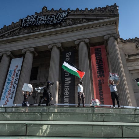 NEW YORK, NEW YORK - MAY 31: Pro-Palestinian demonstrators associated with the 'Within Our Lifetime' protest group, drop a banner at the Brooklyn Museum on May 31, 2024 in New York City. Demonstrators started at Barclays Center and marched to the Brooklyn Museum where they occupied the inside lobby and the outside demanding that the Brooklyn Museum divest from investments in Israel. (Photo by Stephanie Keith/Getty Images)