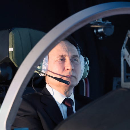 In this pool photograph distributed by the Russian state owned agency, Russian President Vladimir Putin operates a simulator during a visit at the Krasnodar Higher Military Aviation School of Pilots in Krasnodar on March 7, 2024. (Photo by Mikhail METZEL / POOL / AFP) (Photo by MIKHAIL METZEL/POOL/AFP via Getty Images)