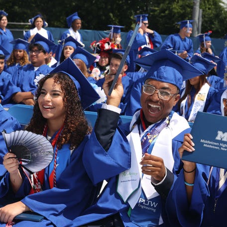 Gianna Boria, Demitri Boucher and TJ Boyd sit together at Middletown High School's commencement ceremony in Middletown, NY on June 26, 2024.
