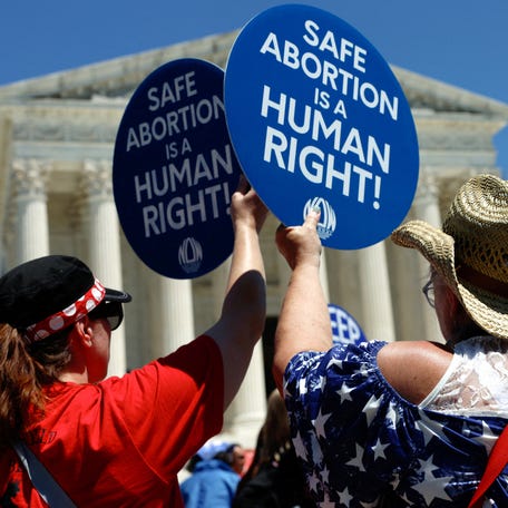 Abortion rights activists hold signs as they gather at the U.S. Supreme Court to mark the second anniversary of the Court overturning Roe v. Wade, in Washington, U.S., June 24, 2024. , U.S., June 24, 2024. REUTERS/Evelyn Hockstein