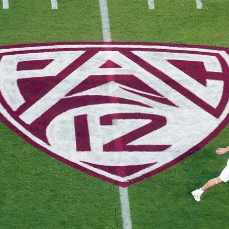 A view of the Pac-12 logo on the field as Stanford Cardinal wide receiver David Kasemervisz (80) warms up.