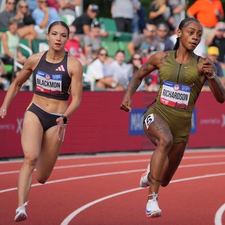 Jun 27, 2024; Eugene, OR, USA; Sha'Carri Richardson defeats Kennedy Blackmon to win women's 200m heat in 21.99 for the top time during the US Olympic Team Trials at Hayward Field. Mandatory Credit: Kirby Lee-USA TODAY Sports