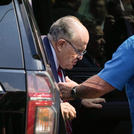 Rudy Giuliani exits his vehicle to speak with the media after he surrendered in Atlanta to be booked as part of county prosecutors' investigation into efforts to overturn the 2020 election in Georgia at the Fulton County Jail Intake Center in Atlanta, GA in Aug 23, 2023. A grand jury in Fulton County, Georgia indicted Donald Trump. The indictment includes 41 charges against 19 defendants, from the former president to his former attorney Rudy Guiliani and former   White House Chief of Staff Mark Meadows. The legal case centers on the stateâ€™s RICO statute, the Racketeer Influenced and Corrupt Organizations Act.