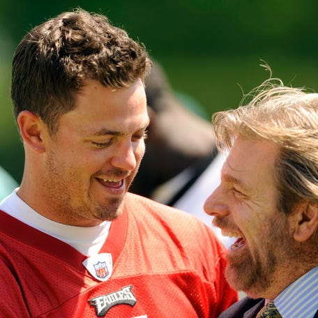 Quarterback Kevin Kolb shares a laugh with local sports reporter Howard Eskin during the Eagles' 2010 minicamp.