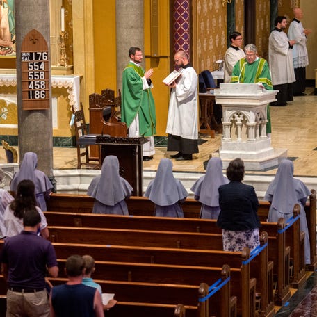 Parishioners worship in every other pew as public Mass resumes Sunday, June 21, 2020 at St. Mary's Cathedral and throughout the Catholic Diocese of Peoria. Public Mass was suspended after March 14 due to the coronavirus pandemic.