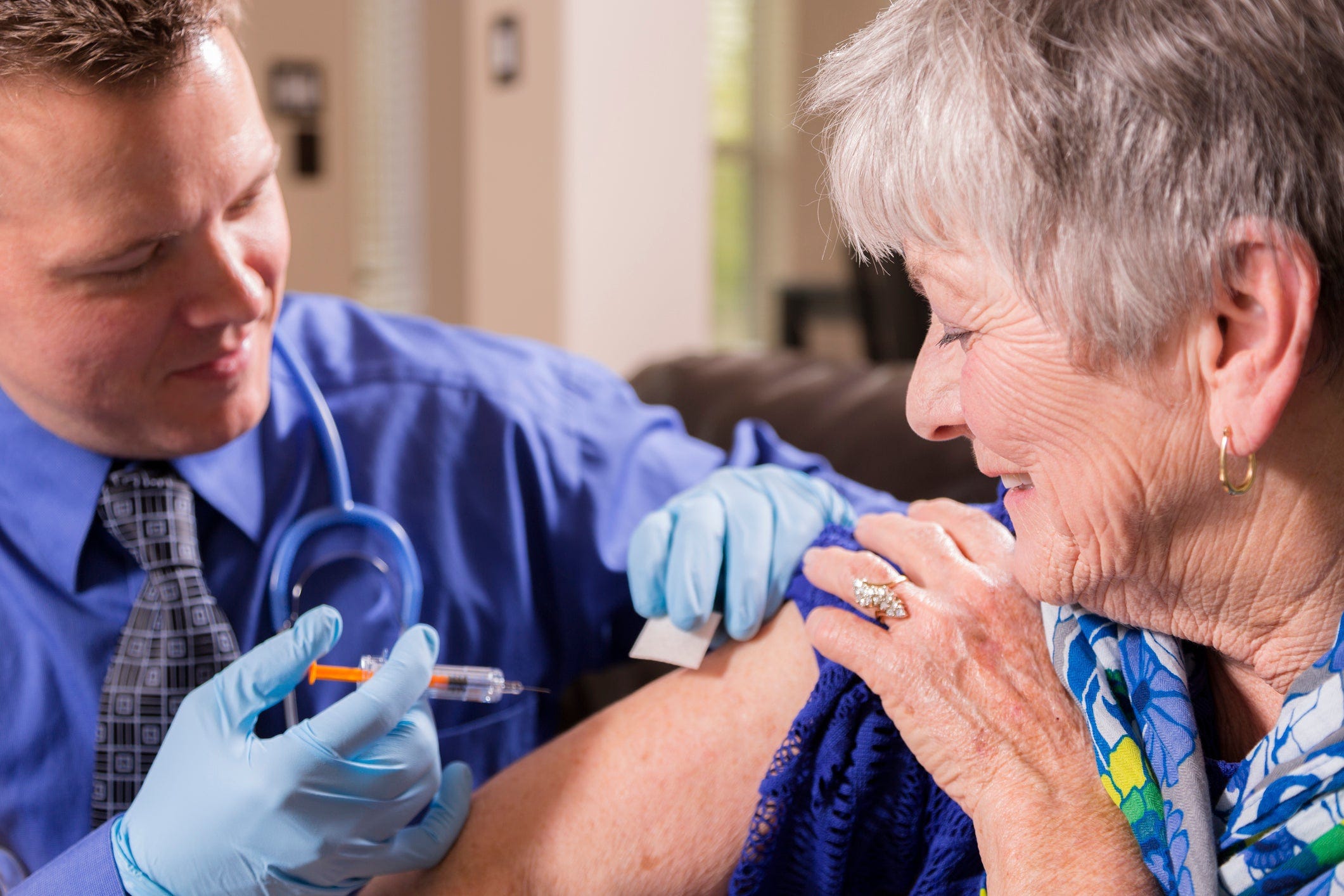 Doctor Giving Vaccine Flu Shot To Senior Getty