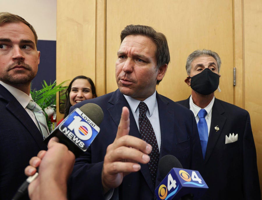 Florida Gov. Ron DeSantis responds to reporters' questions Monday in Miami.