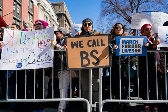 People take part in a march rally against gun violence Saturday in New York. Tens of thousands of people poured into the nation's capital and cities across America on Saturday to march for gun control and ignite political activism among the young. 