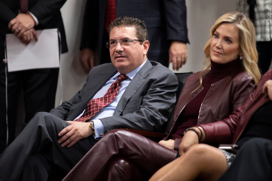 FILE - Washington Redskins owner Dan Snyder, left, and his wife Tanya Snyder, listen to head coach Ron Rivera during a news conference at the team's NFL football training facility in Ashburn, Va., in this Thursday, Jan. 2, 2020, file photo. Dan Snyder's wife Tanya was named co-CEO of the Washington Football Team on Tuesday, June 29, 2021, giving her bigger influence in the club that is currently in the midst of an independent investigation into workplace conduct the NFL is overseeing. (AP Photo/Alex   Brandon, File)