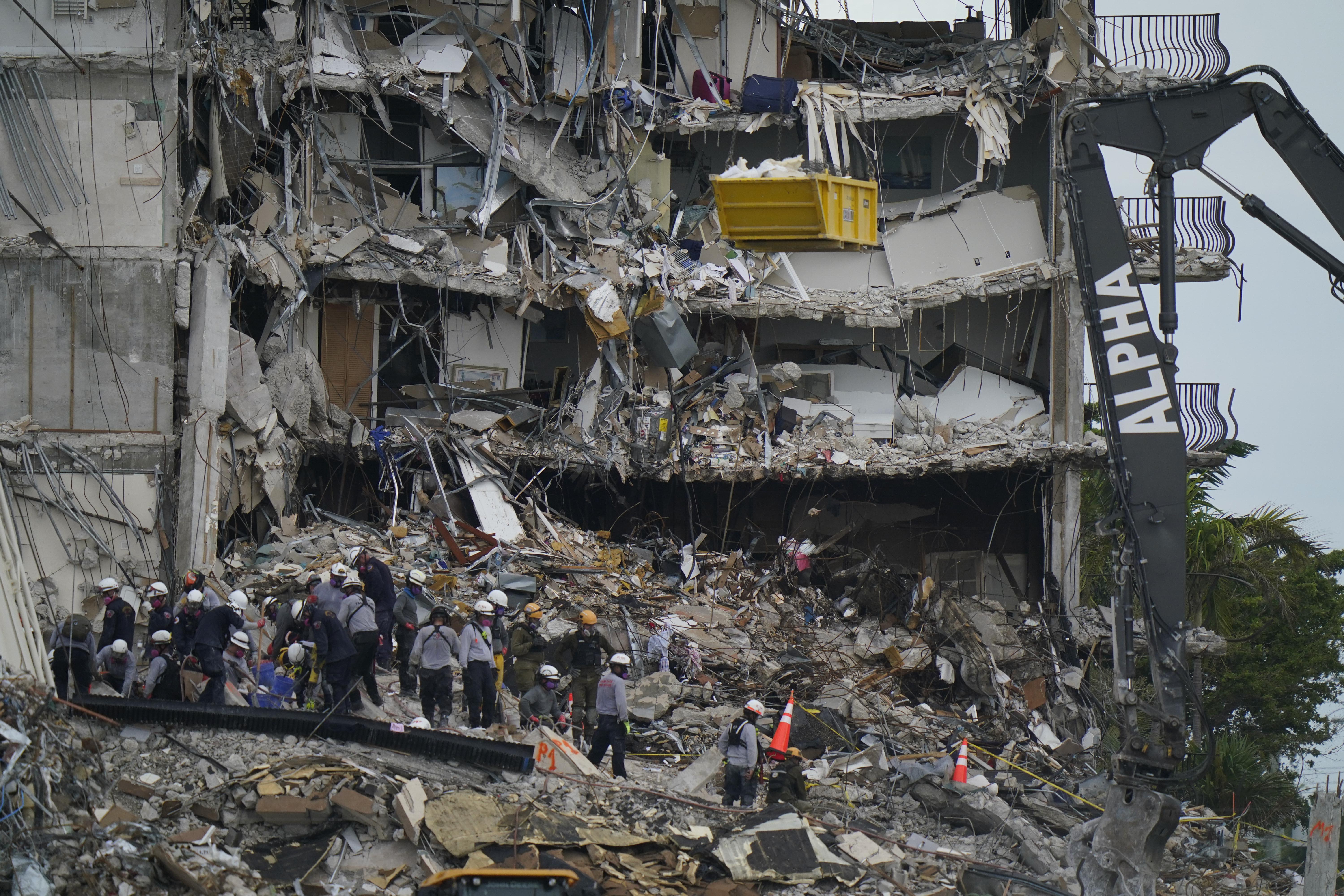 Search and rescue personnel work atop the rubble at the Champlain Towers South condo building in Surfside, Fla., on June 30.