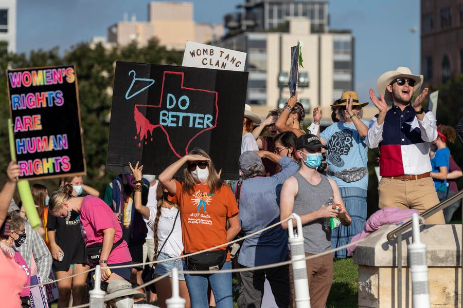 People protest the state's abortion law at the Women's March ATX rally Saturday at the Texas State Capitol in Austin.