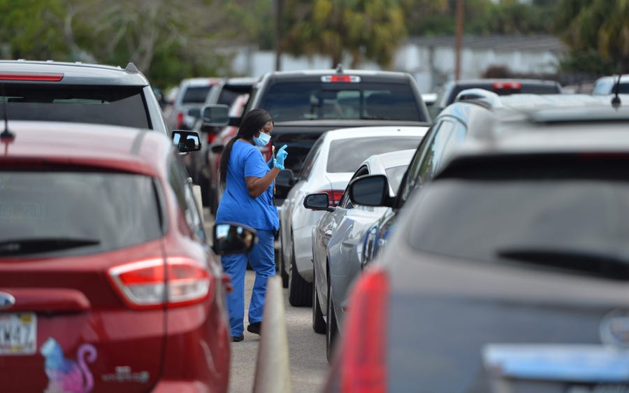 People waited more than four hours Thursday morning for COVID-19 testing at the state testing site at the Sarasota Kennel Club in Florida. (Mike Lang/Sarasota Herald-Tribune)