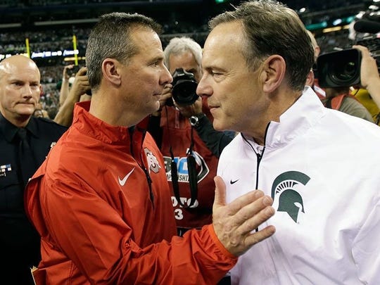 Urban Meyer, left, and Mark Dantonio meet, after the Spartans beat the Buckeyes in the 2013 Big Ten championship game.
