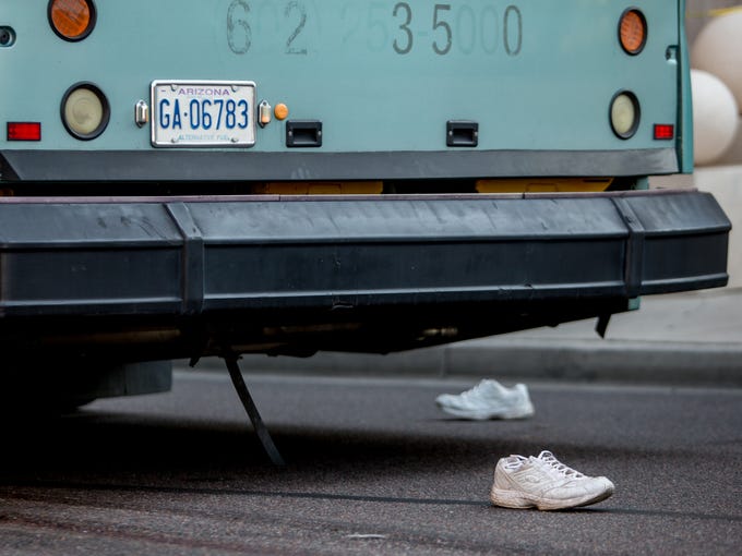 A pedestrian's shoes are seen on August 1, 2018, after being struck by a city bus on the corner of 1st Avenue and East Van Buren Street.