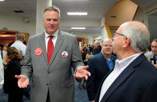 In this archival photo, Mike Dunleavy, then a candidate for governorship, attends a meeting in a church in Anchorage, Alaska.