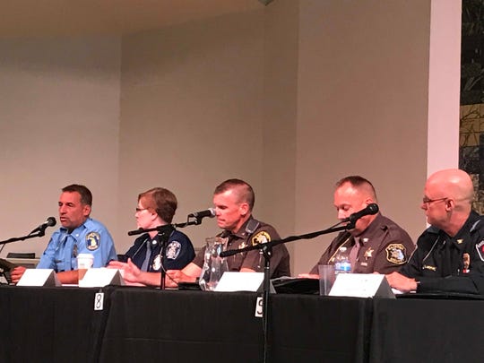 From left, Lansing Police Chief Michael Yankowski, Michigan State University Uniform Division Captain Kelly Roudebush, Ingham County Sheriff Scott Wrigglesworth, Clinton County Undersheriff Fritz Sandberg and East Lansing Police Chief Larry Sparkes speak during a police-community relations forum on Thursday, August 23. 2018 at  the Unitarian Universalist Church of Greater Lansing.