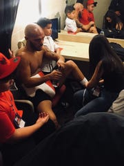 Ray Beltran and his three children comfort one another in the dressing room after his 12-round decision loss to Jose Pedraza on Saturday night at Gila River Arena in Glendale.
