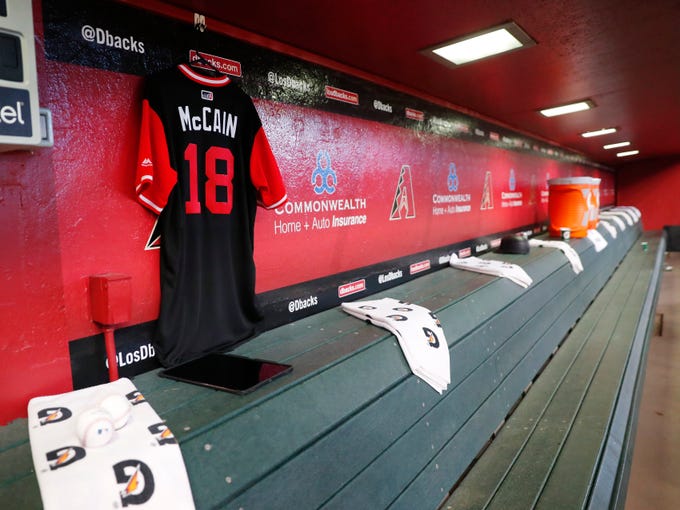 A jersey for Sen. John McCain hangs in the dugout before the Arizona Diamondbacks play against the Seattle Mariners at Chase Field in Phoenix, Ariz. August 26. 2018. The six-term Arizona senator died Saturday at age 81.