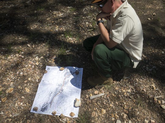 Mike Dechter, NEPA coordinator for the Coconino National Forest, looks at a map of the General Springs Timber sale in the forest north of Payson.