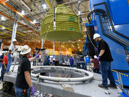 The technicians are working on the Orion spacecraft scheduled for Mission 2 at NASA's Michoud Assembly Facility, near New Orleans, Louisiana.