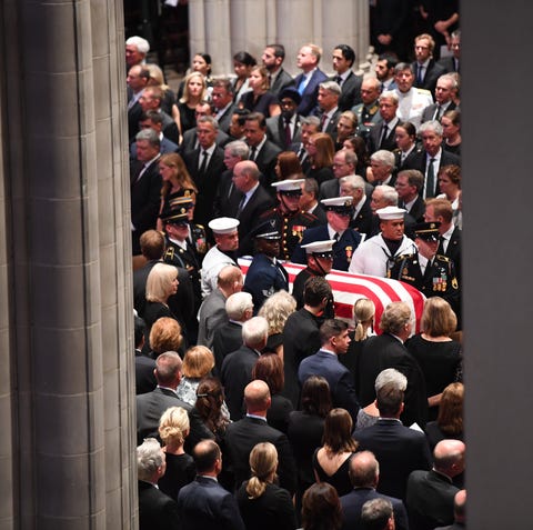 The casket of John McCain is carried by the honor...